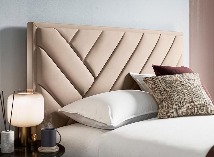 Taupe velvet-finish bed frame, styled in a neutral bedroom with a side table and plush cushions