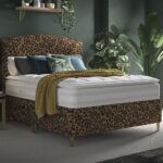 Animal print bedroom decor ideas - Leopard print headboard and divan base in a green bedroom with plants
