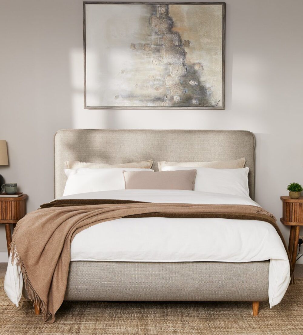 japandi style bed in a japandi bedroom with muted earthy bedding, bed frame, and walls