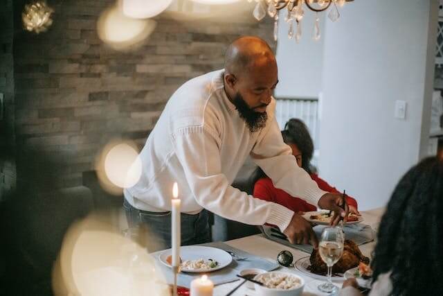 Man dishing Christmas dinner