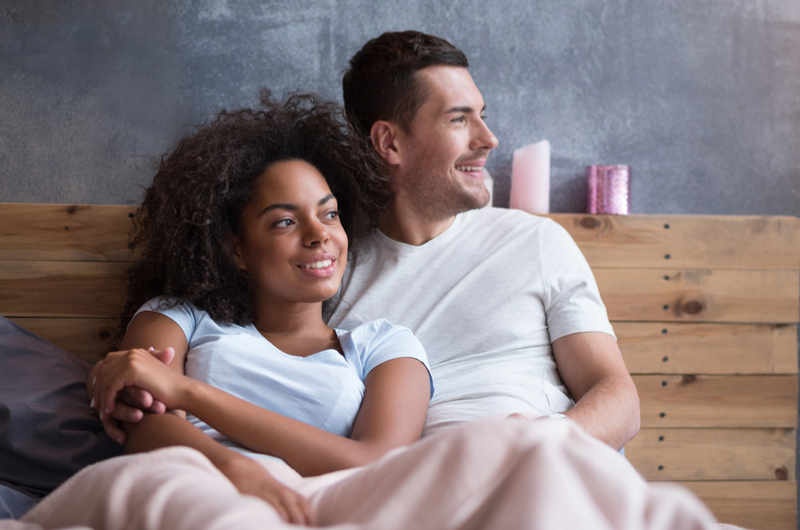 Couple happy in bed.