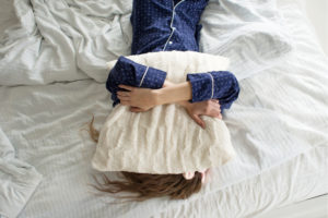 Woman in bed wearing pyjamas
